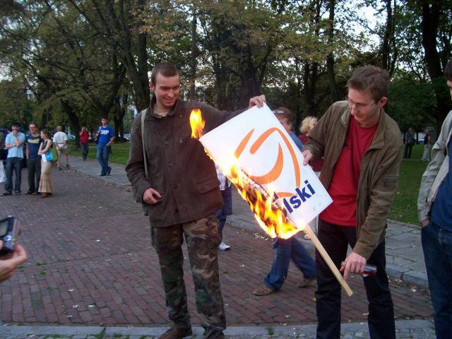 'for Poland' adver banner of Citizens' Platform being burned